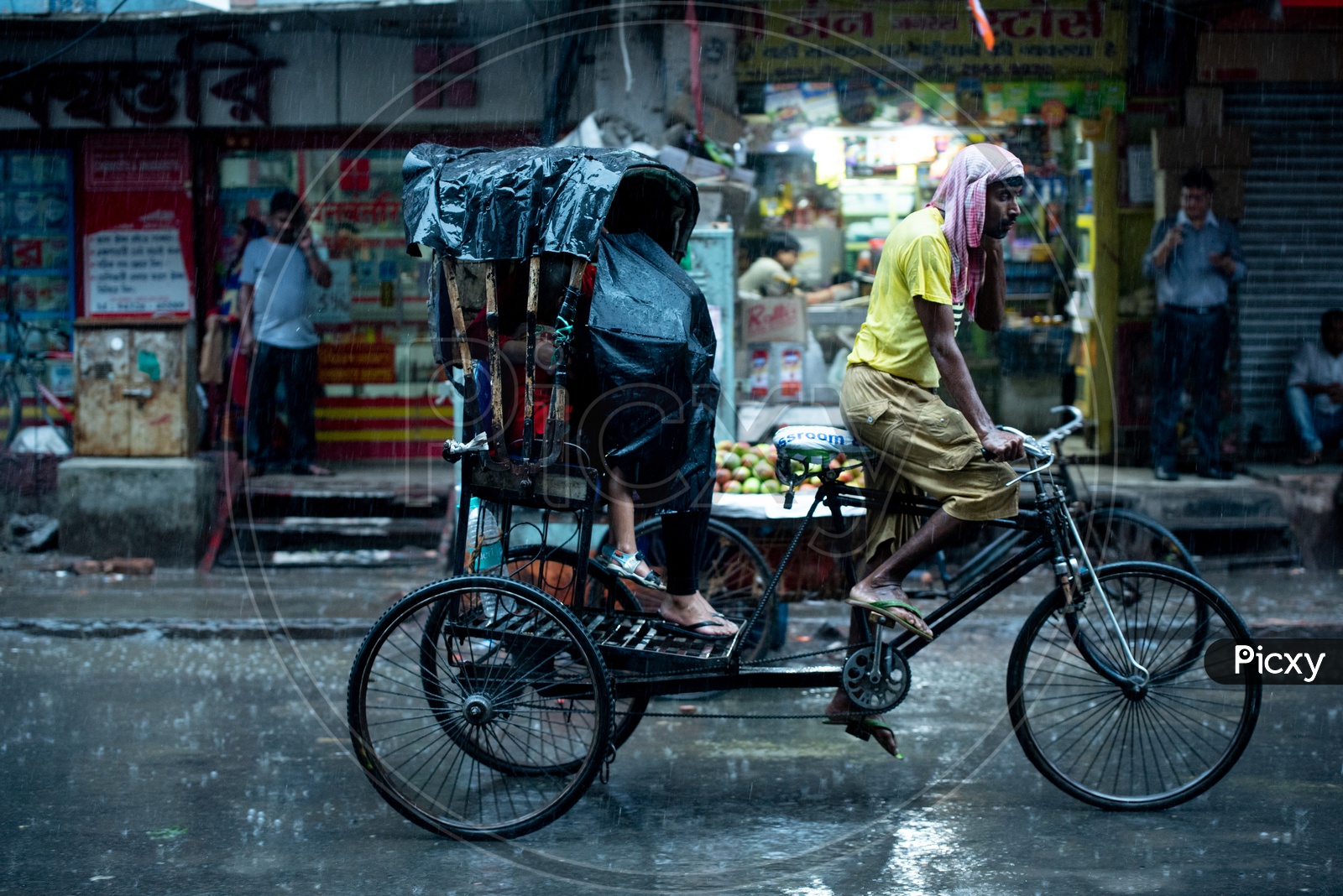 Rickshaw Puller  Or Rickshaw Man Riding The Rickshaw On  Howrah Streets in Heavy Rain Due To Cyclone  Fani