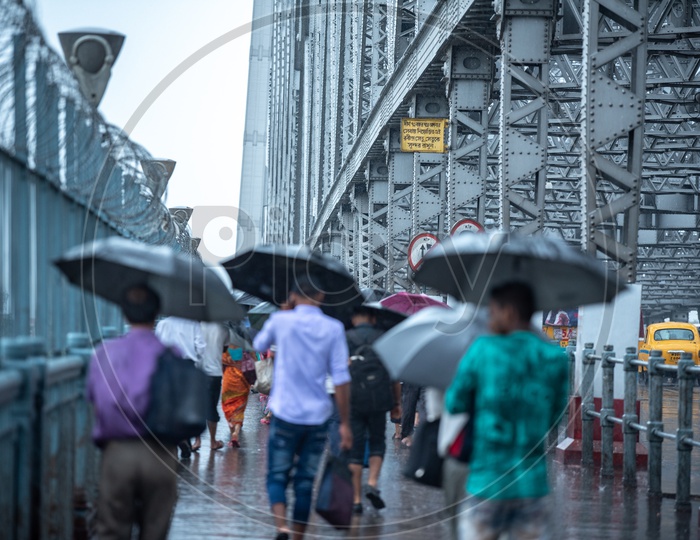 Pedestrians At Howrah Bridge   using Umbrellas  To Take  Cover From Heavy Rain  Due To Cyclone Fani   in Kolkata