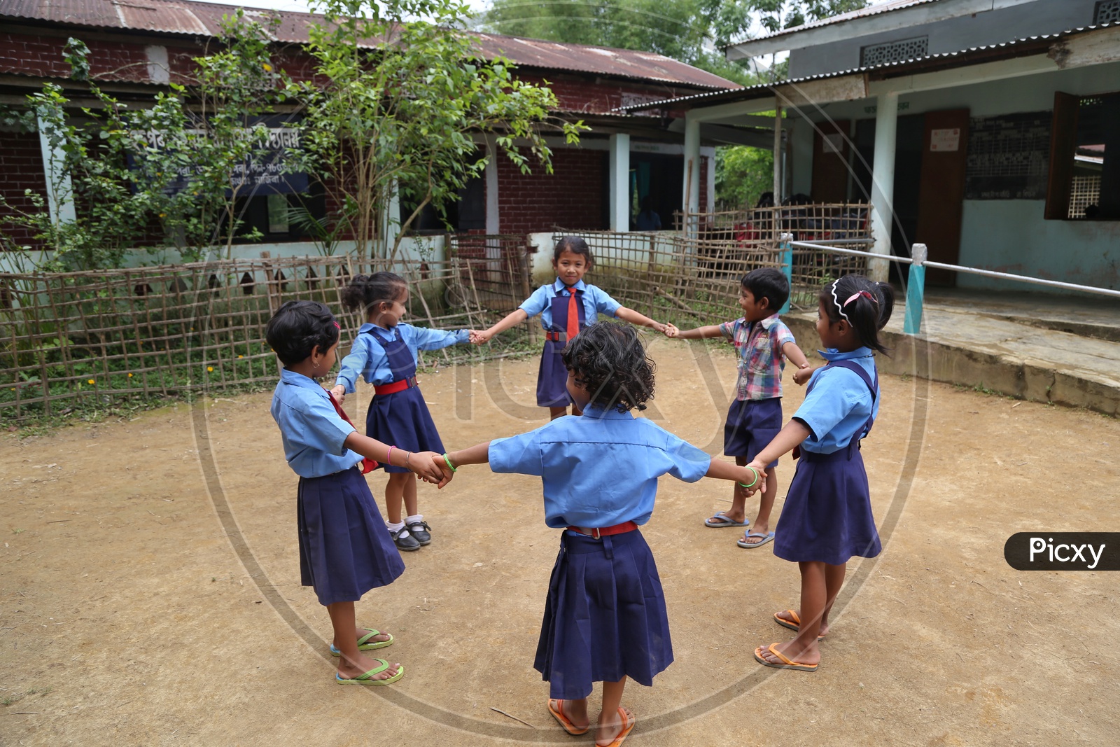 School children Or  School Students Wearing Uniforms And Playing Happily  in a Rural Village School Compound Or Premise