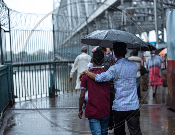 Pedestrians Taking  Cover  Using  Umbrellas In Heavy Rain Due To  Cyclone  Fani   At Howrah  Bridge