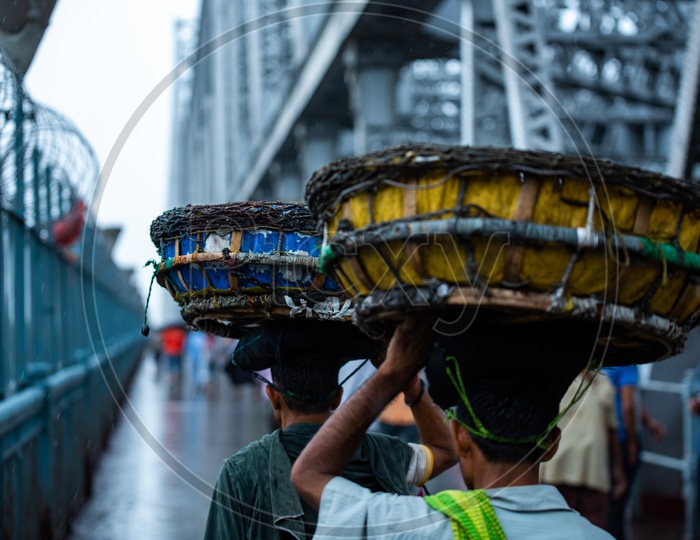 Vendors Carrying The Baskets On Their Heads  At Howrah Bridge