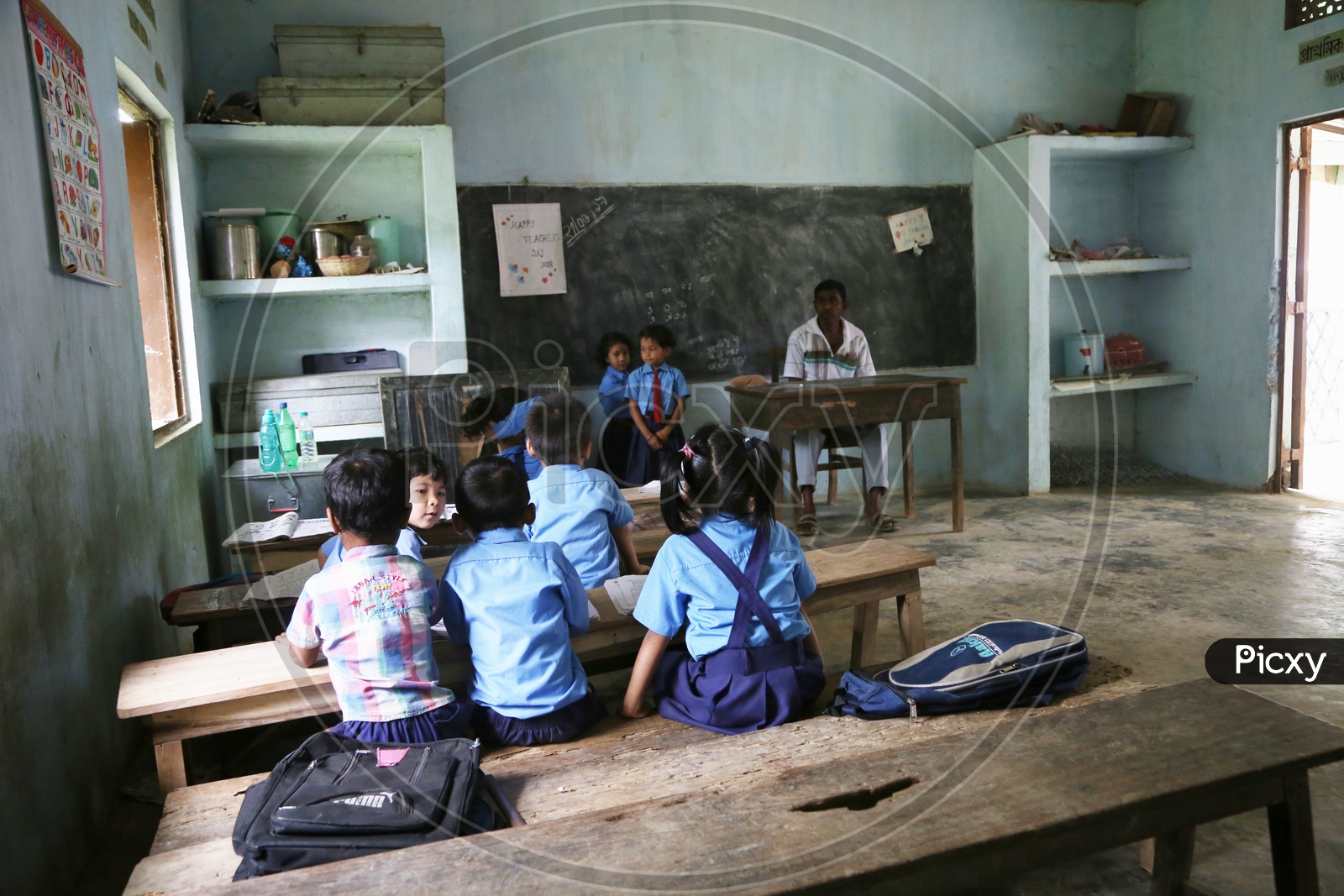 School Students Or School Children Wearing Uniforms  In a Classroom With Books