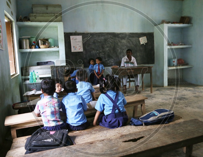 School Students Or School Children Wearing Uniforms  In a Classroom With Books