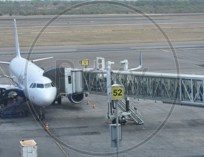 Passengers Boarding  A Flight  In  an  Airport