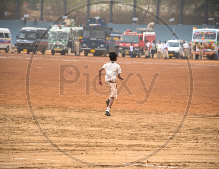A School Boy Running In a Ground