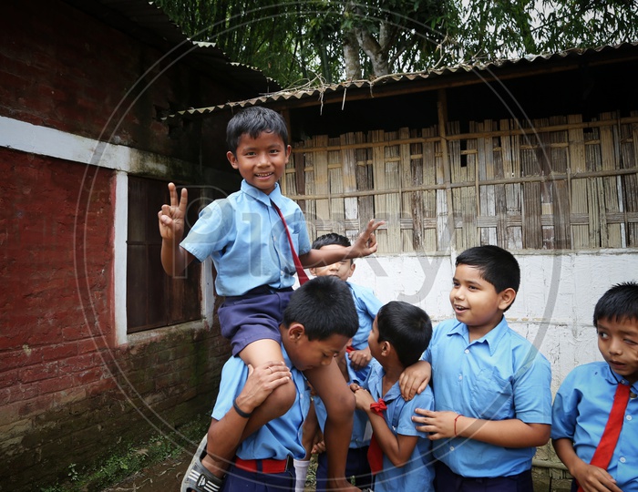 School Children Or School Students Wearing Uniforms  with Happily Smiling Faces   In a Rural Village School Premise Or Compound