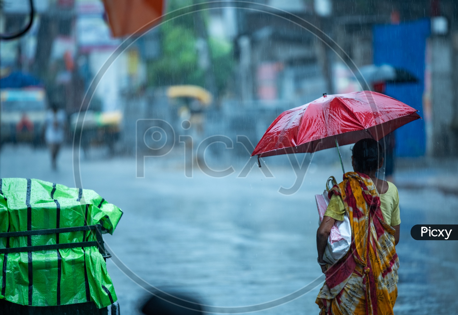 A Woman  Pedestrians  Holding  umbrellas And Taking Cover from Heavy  Rain  Duer To Cyclone Fani  on  Howrah  Roads