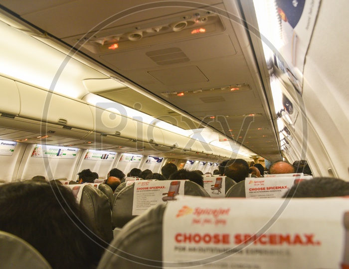 Flight  Inside Shot With  Passengers Siting On Seats And  Interior  Of Flight