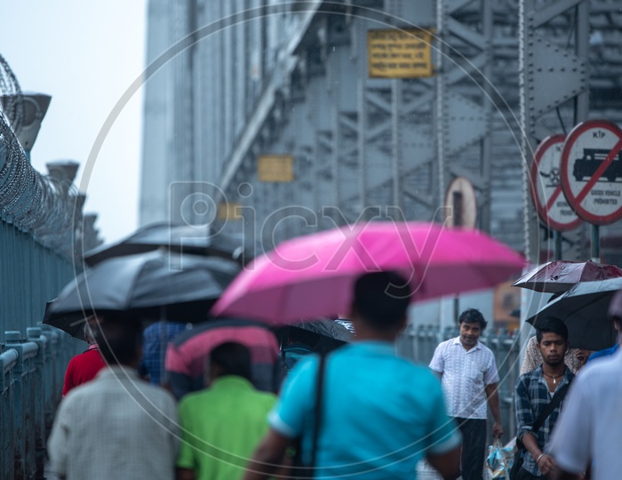 Pedestrians Taking  Cover  Using  Umbrellas In Heavy Rain Due To  Cyclone Fani  At Howrah  Bridge