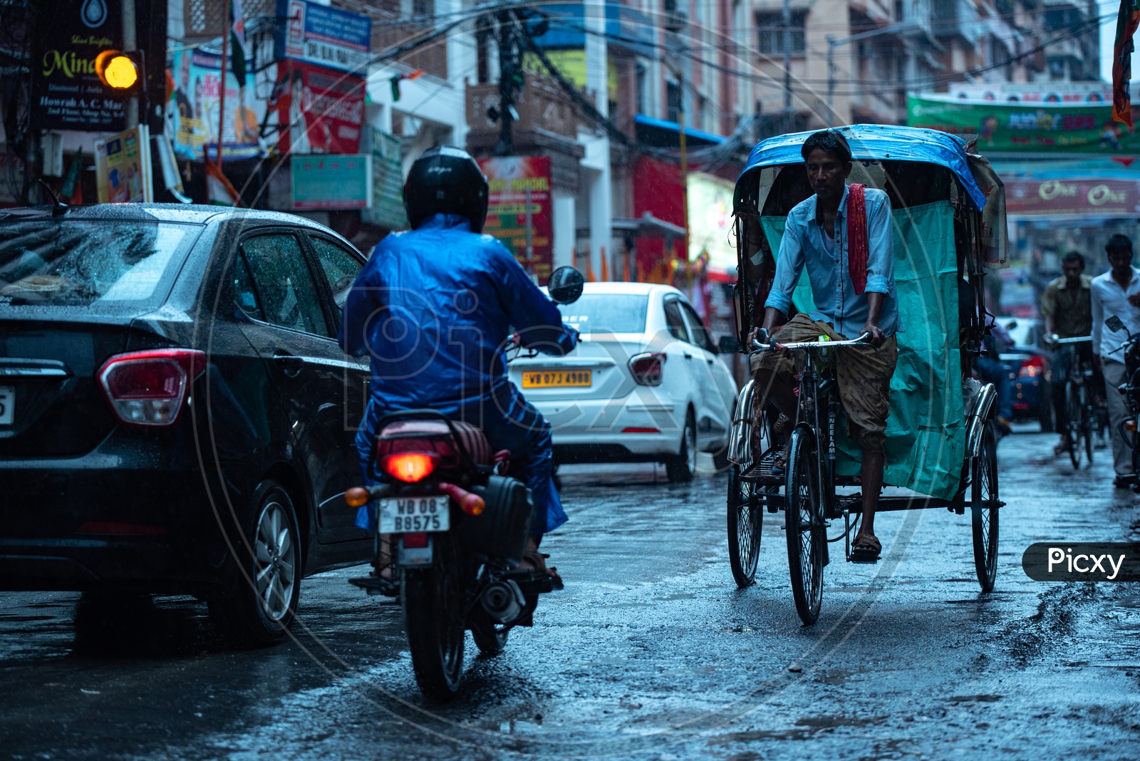 Rickshaw Puller  Or Rickshaw Man Riding The Rickshaw On  Howrah Streets in Heavy Rain Due To Cyclone  Fani