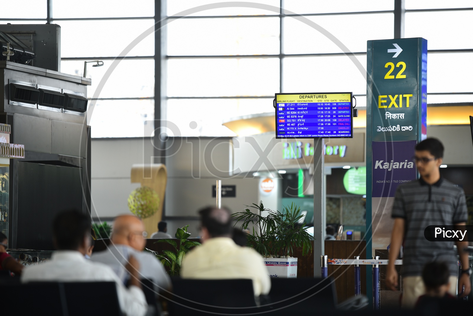 Airport scenes  With Passengers Waiting In  Waiting Lounge  And Departure Display  Screens