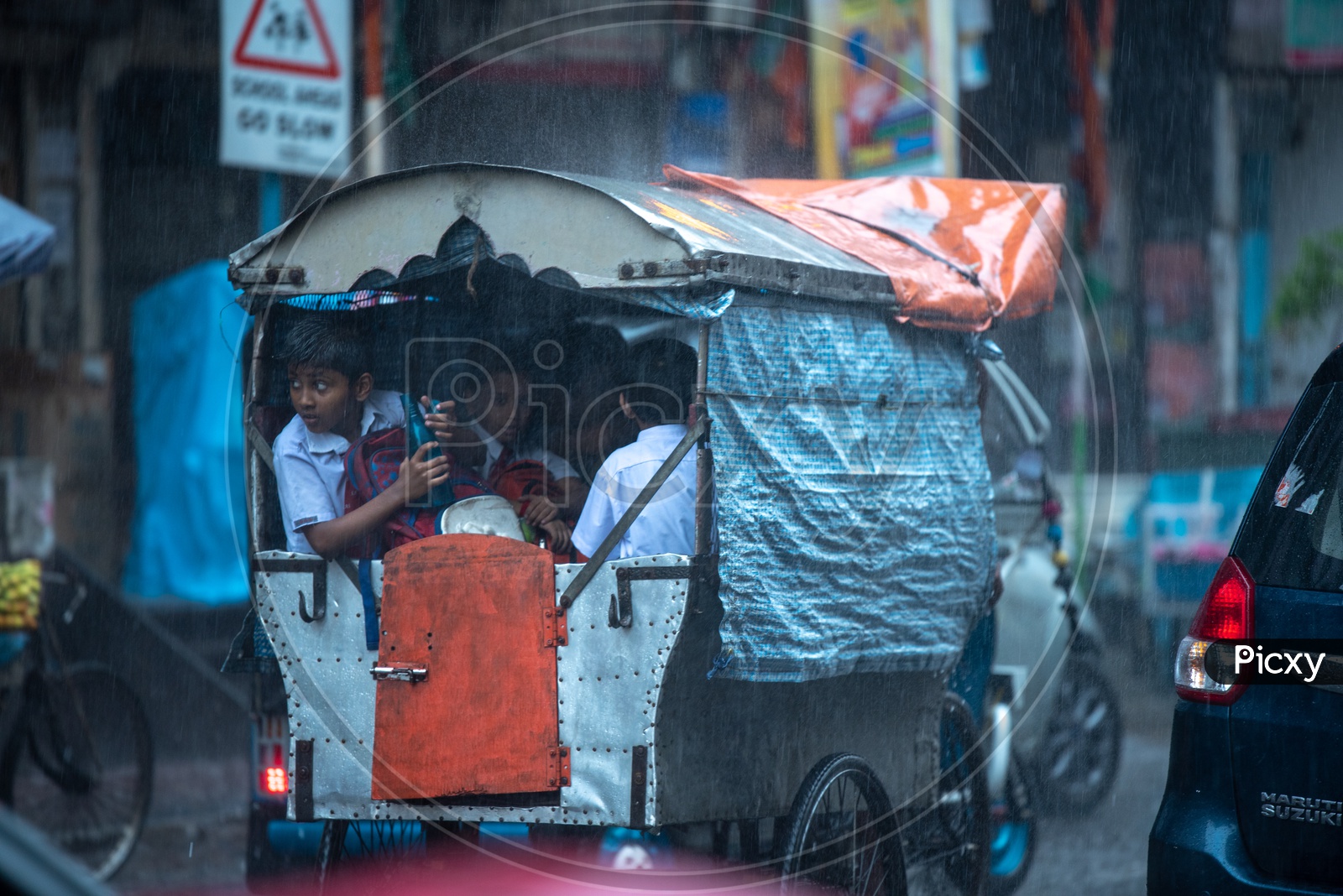 School Children In a Auto Going   To a School On a  Rainy  Day In Kolkata