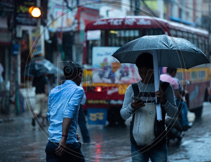 Pedestrians  Holding  umbrellas And Taking Cover from Heavy  Rain  Duer To Cyclone  Fani  on  Howrah  Roads