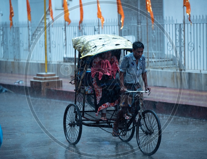 Rickshaw Puller or Rickshaw man  Riding  Rickshaw  on Howrah Roads  in  Heavy  Rain  Due To  Cyclone  Fani