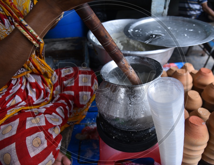 Churning Of Lassi  With a Wooden Churner  In a Vendor Stall