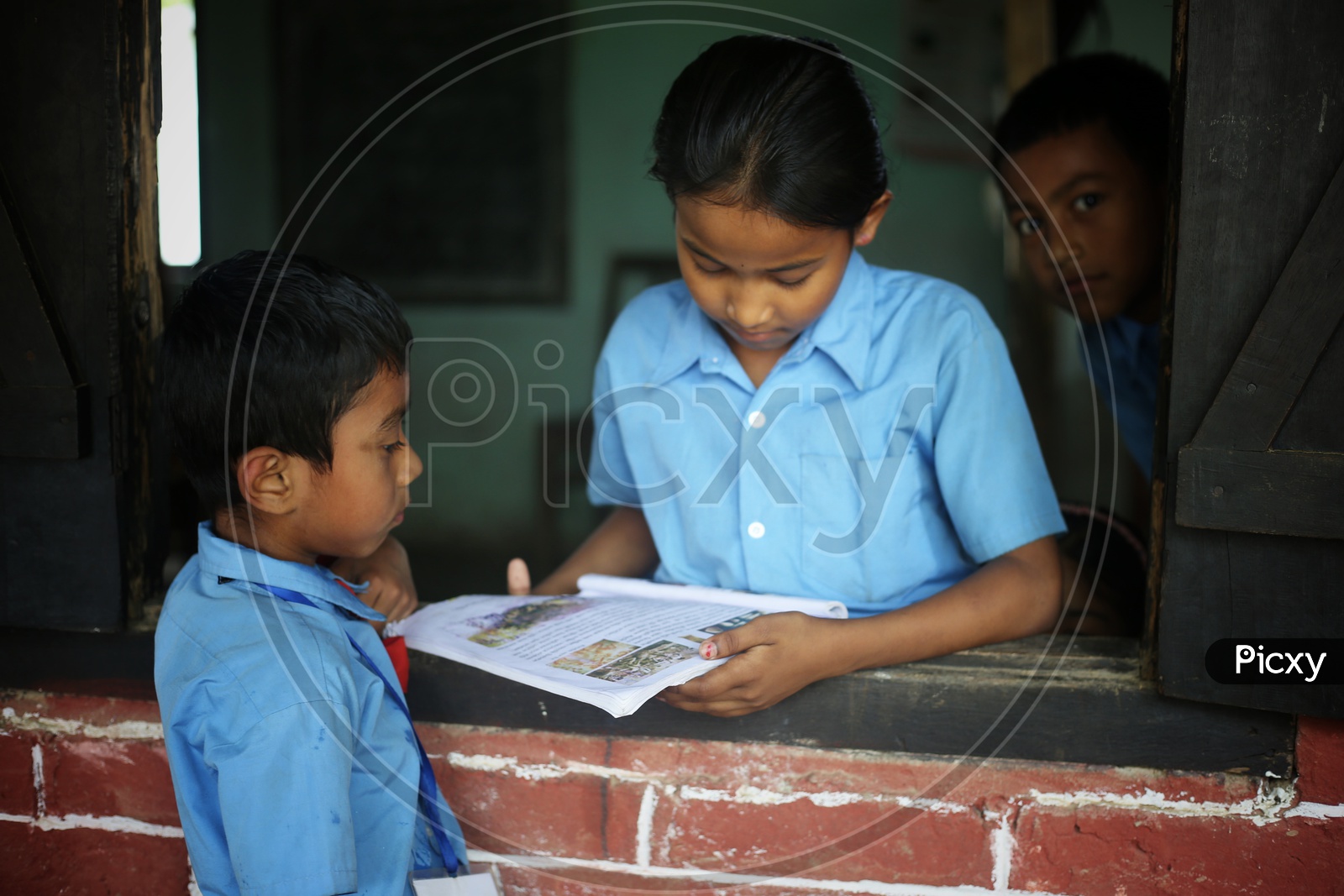 School Children Or School Students  Wearing Uniform  in a School Classroom With Books