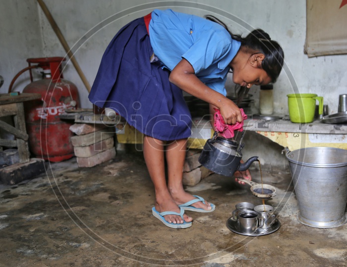 A School Girl Wearing Uniform And Making Tea in a Rural Village House