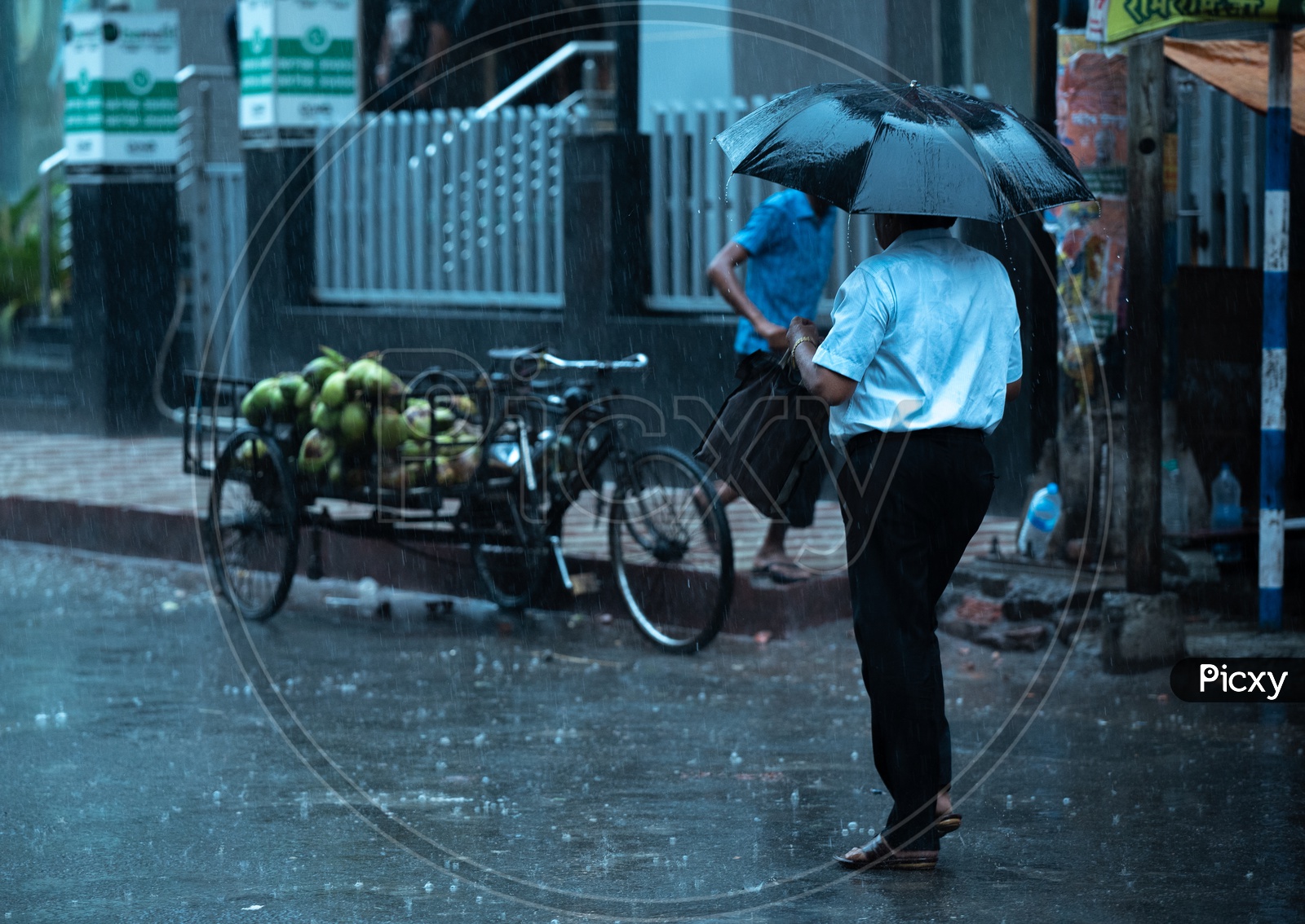 Pedestrians  Holding  umbrellas And Taking Cover from Heavy  Rain  Duer To Cyclone Fani  on  Howrah  Roads