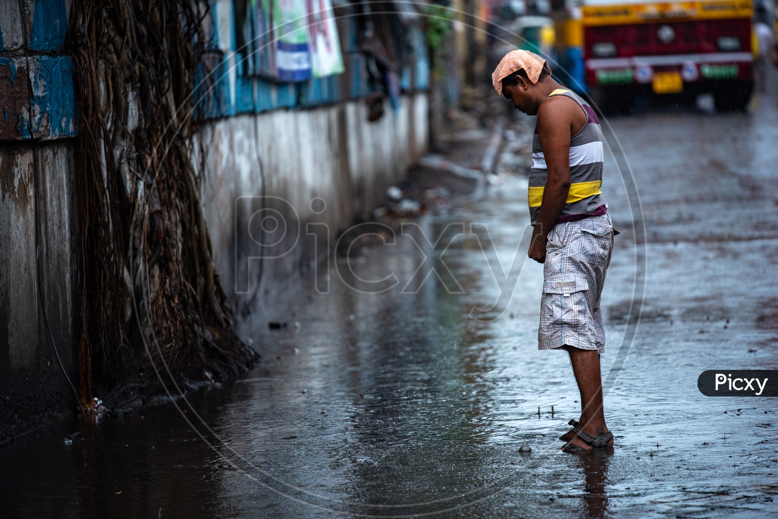 Image of A Man peeingpublic urination on Over Flooded Roads in Kolkata 