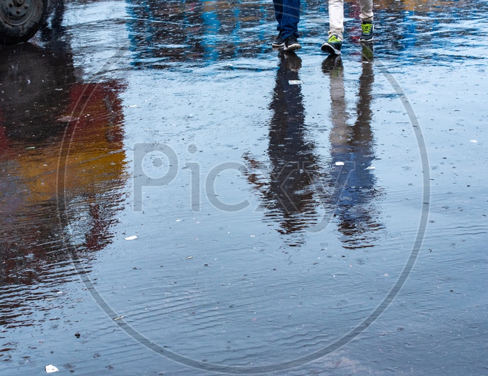 Reflection Of a Couple Man Walking On  Water Filled  Roads in Kolkata  Due To Cyclone Fani