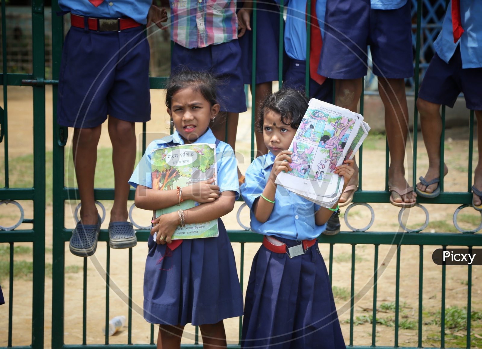 School Girls Wearing Uniform And Holding Books In Hand In a Rural Village School