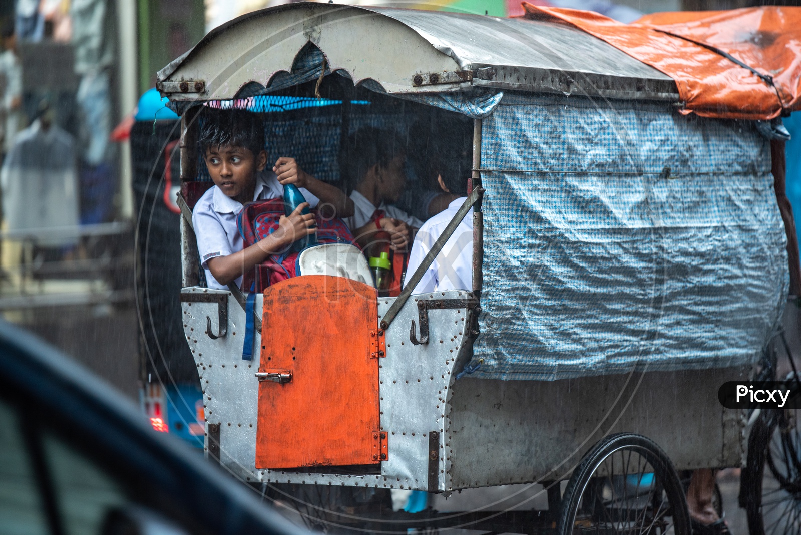 School Children In a Auto Going   To a School On a  Rainy  Day In Kolkata