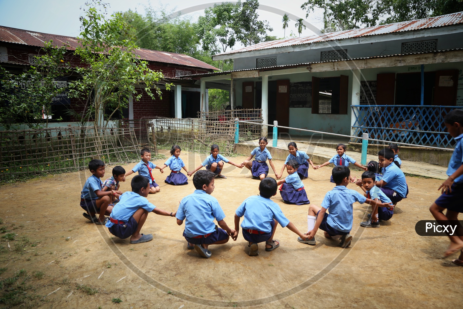 School Children Or School Students Wearing Uniforms With Happily Smiling Faces  Playing In  A School Premise Or Compound