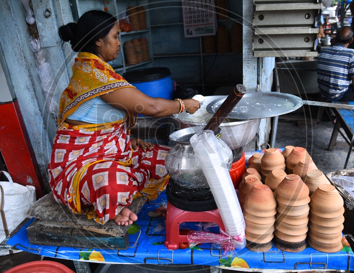 A Woman Vendor  Making Lassi  at a Vendor stall In Howrah