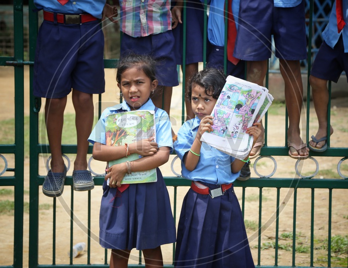 School Girls Wearing Uniform And Holding Books In Hand In a Rural Village School