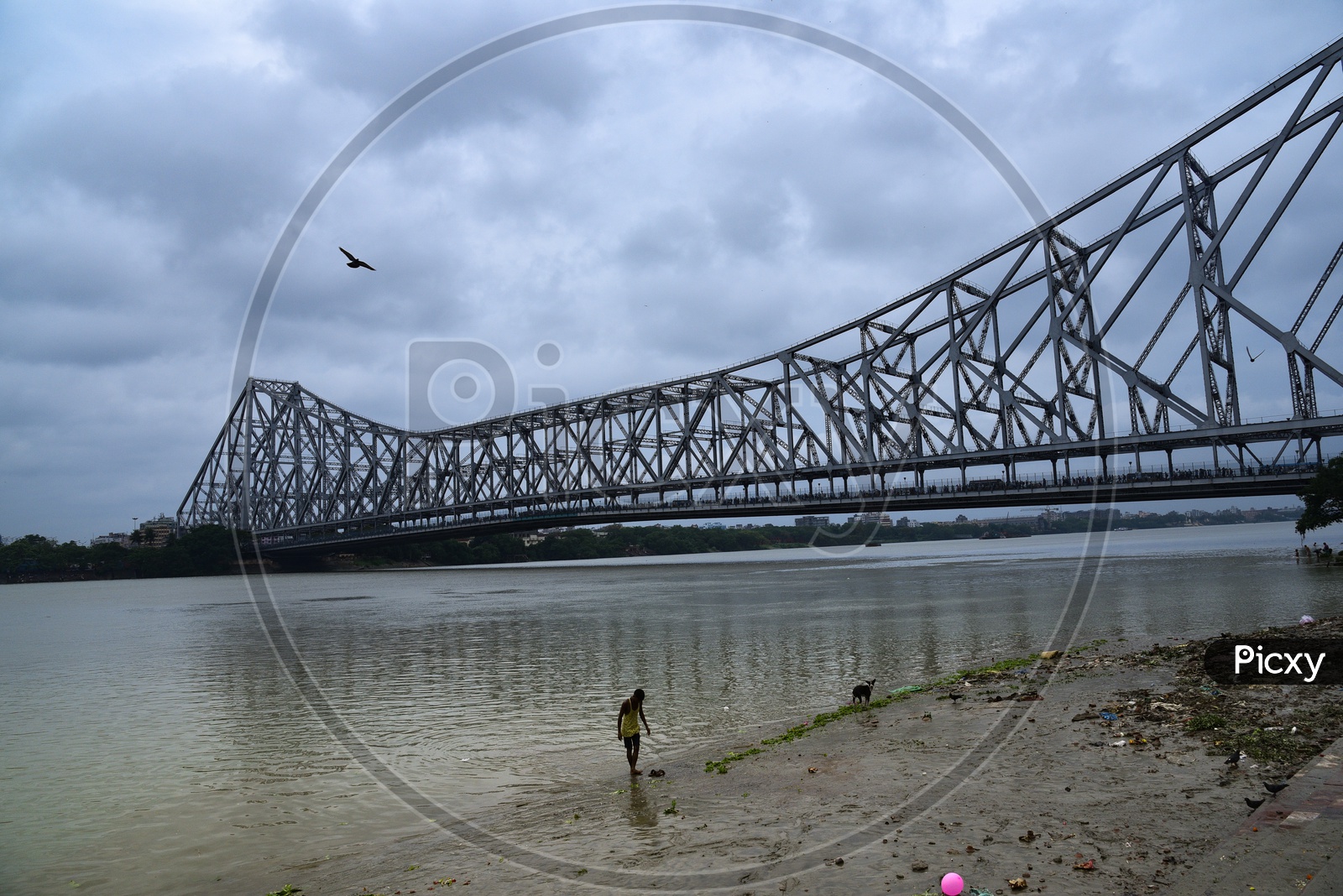 Local People At The Bank Of Hooghly River with  Howrah Bridge   In Background