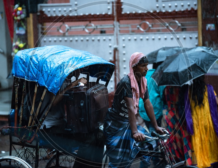 Rickshaw Puller or Rickshaw man  Riding  Rickshaw  on Howrah Roads  in  Heavy  Rain  Due To  Cyclone Fani