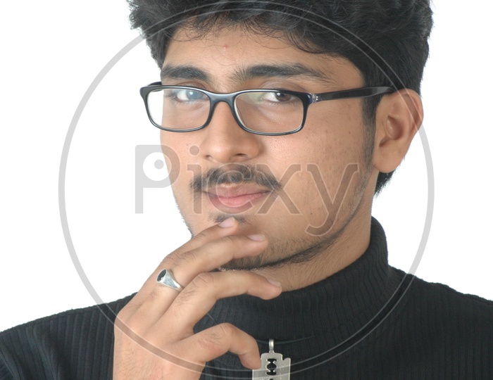Portrait Of a Young Indian Man  With an Expression  Wearing Spectacles And Posing On an Isolated White Background