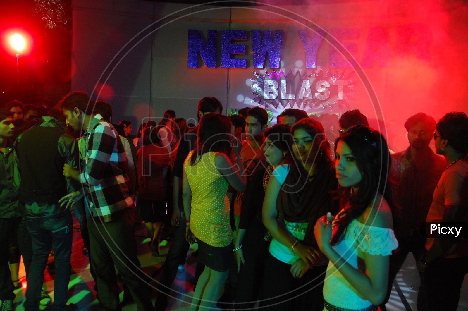 Group Of Young People Dancing In a Disco or Pub  on a new Year Event