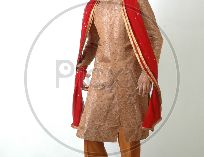 A  Young Indian Man In traditional Ethnic  Wear  or Sherwani   and Posing With a Smile Face On an Isolated White Background