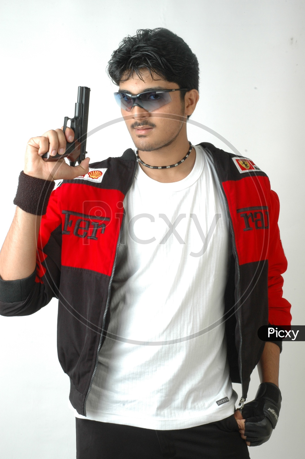 Action hero muscled man holding a gun. Wearing black t-shirt and Stock  Photo by ©ysbrand 47501467