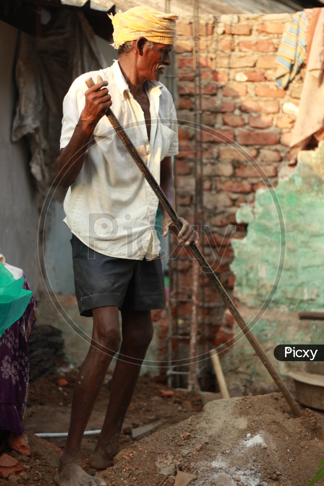 Indian Man holding an Iron Crowbar