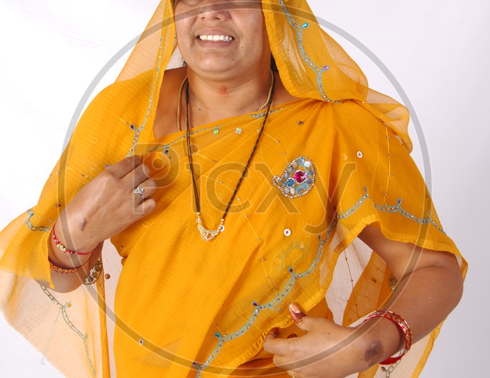 An Indian Woman In Casual Saree or Sari  And Veil Over Her Head  and With A Smile Face on an Isolated White Background