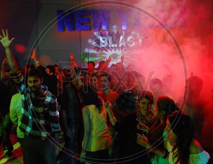 Group Of Young People Dancing In a Disco or Pub  on a new Year Event