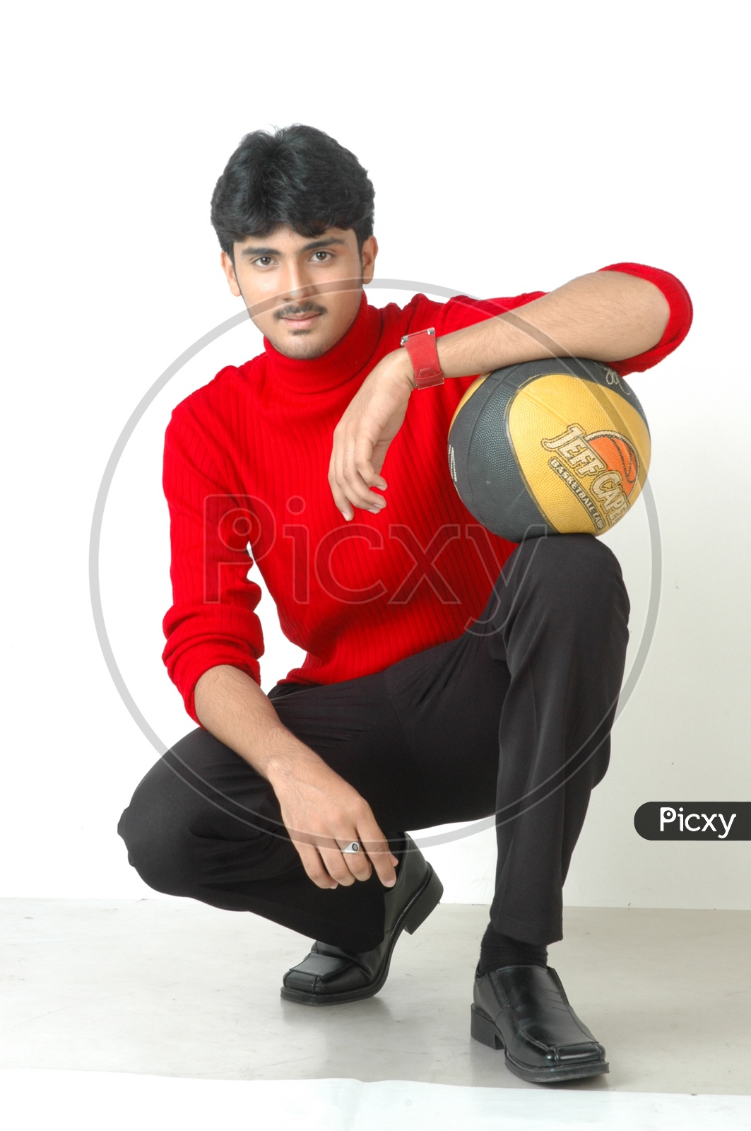 An Indian  Young Man With a Basket Ball In Hands And Posing On an Isolated White Background