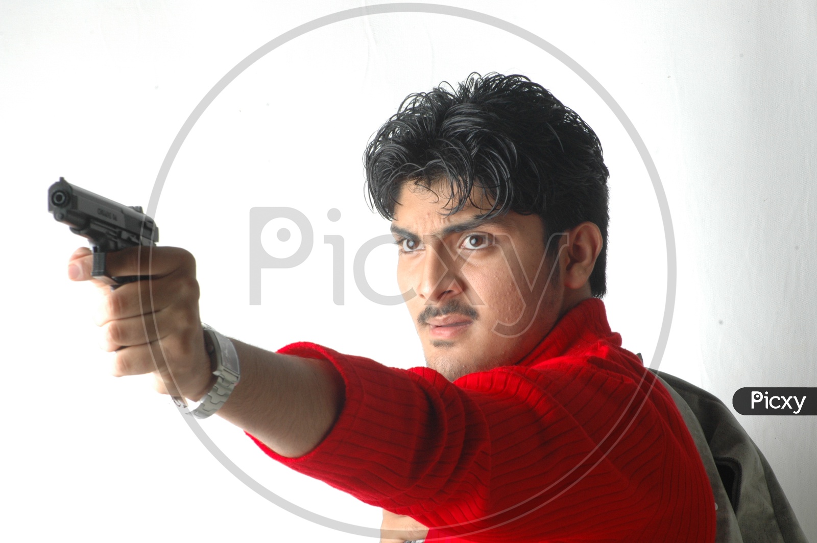 A Young Indian Man Holding Gun  And  Posing  On an Isolated White Background