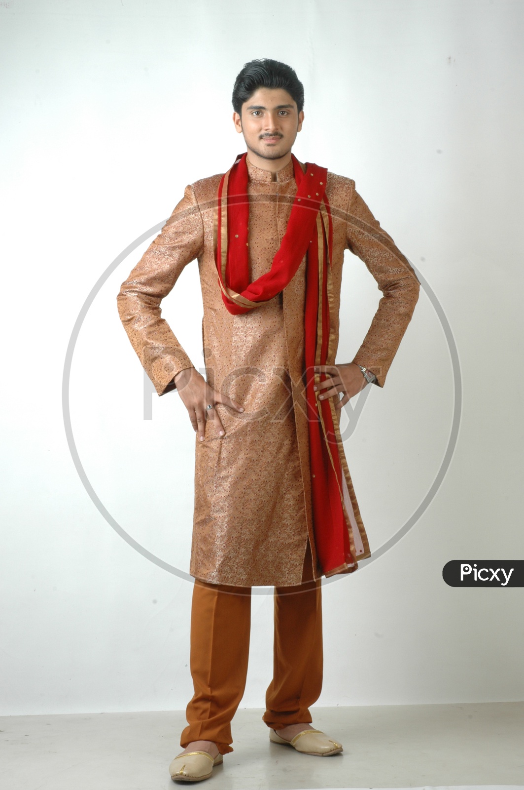 A  Young Indian Man In traditional Ethnic  Wear  or Sherwani   and Posing With a Smile Face On an Isolated White Background