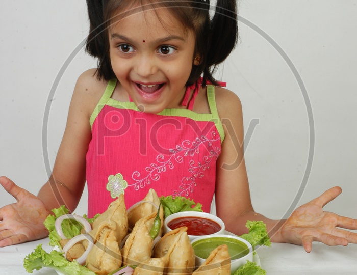 An Indian Girl at  Samosas Plate With an Expression on an Isolated White Background