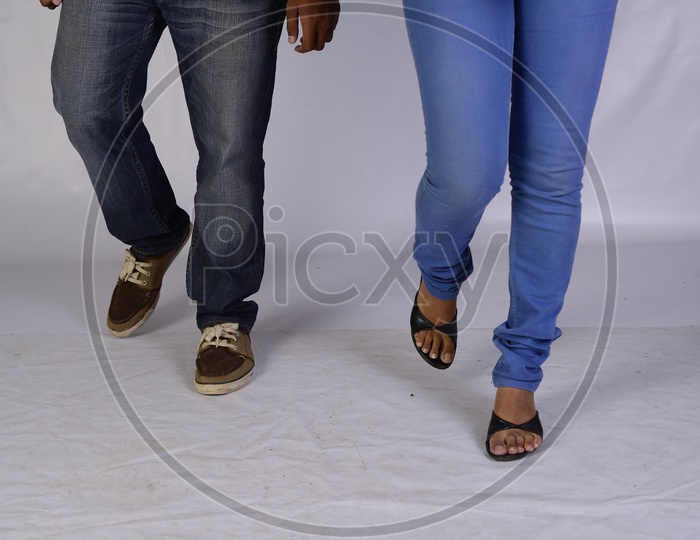 A Young Indian Couple Or  Lovers  Walking  Alone On an Isolated White Background  Legs Closeup