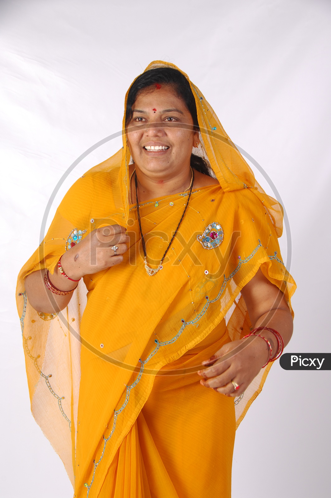 An Indian Woman In Casual Saree or Sari  And Veil Over Her Head  and With A Smile Face on an Isolated White Background