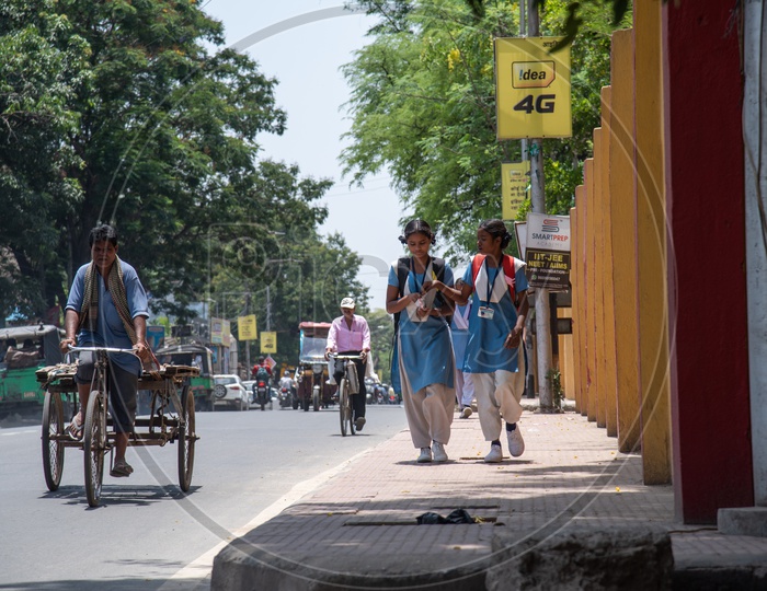 School Girls In Uniforms  Walking  on Footpaths While Going To School