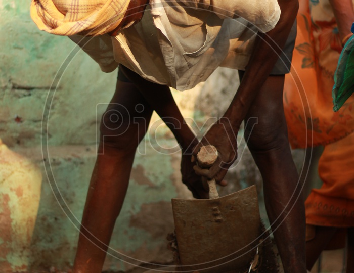 Indian Man holding a pickax