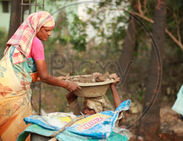 Indian Female Worker handling the Construction Ghamela