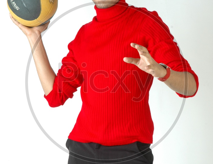 An Indian  Young Man With a Basket Ball In Hands And Posing On an Isolated White Background
