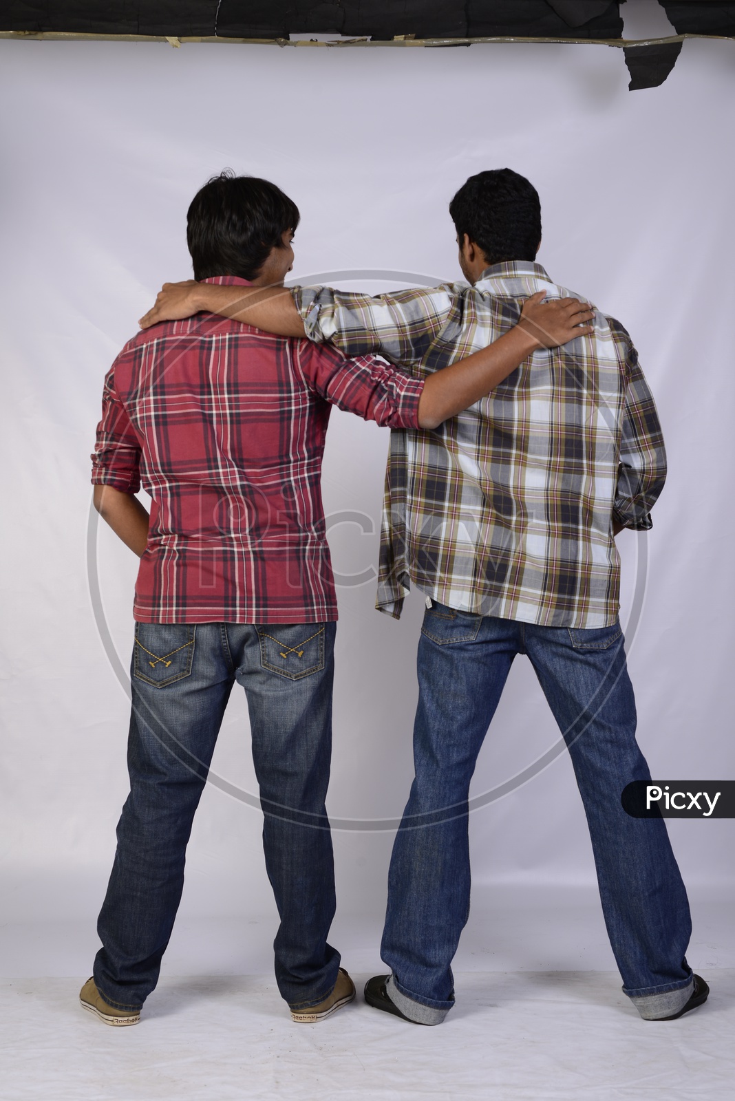 A Couple Of Boys Or Friends With Hands On Their Shoulders On Each  Other   Standing  On An Isolated White Background