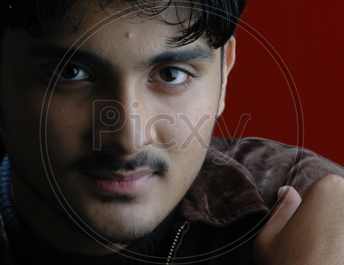 Portrait  Of a Indian Man  With Smile Face On an Isolated Red Background